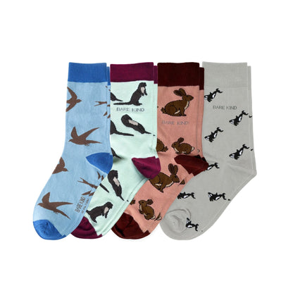 Four pairs of socks with animal patterns on a white background