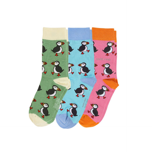 Set of three colorful socks with puffin patterns on a white background