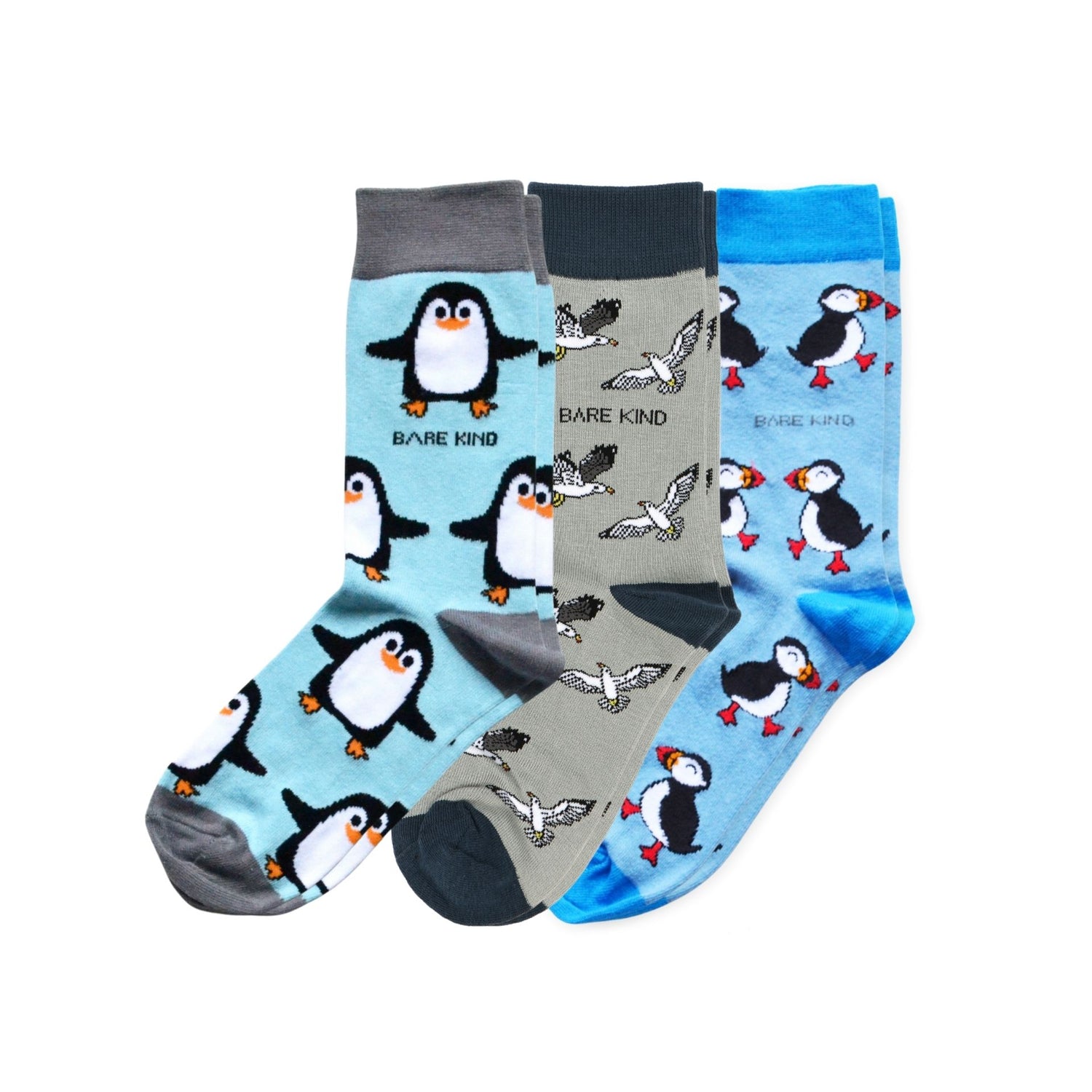 Three pairs of socks with penguin and bird patterns on a white background