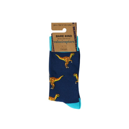 Blue sock with dinosaur pattern and Bare Kind packaging on a white background