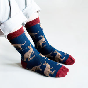 side angle view of sitting model in dark blue wallaby bamboo socks