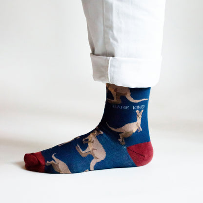 side profile view of standing model wearing dark blue wallaby bamboo socks 