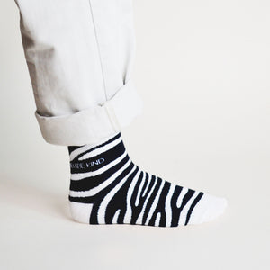 side view of standing model wearing zebra print bamboo socks