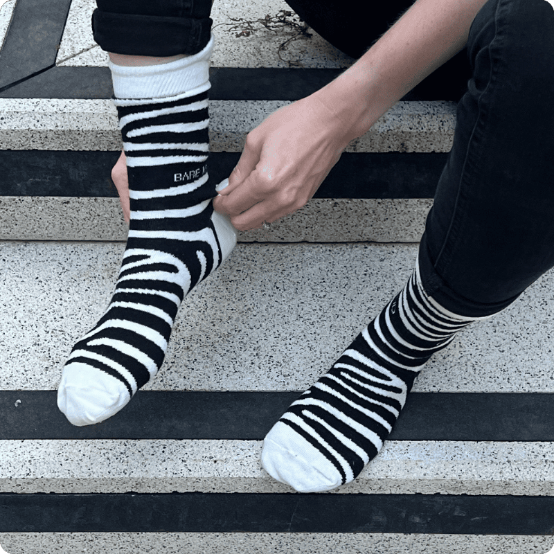 Model wearing zebra print bamboo socks