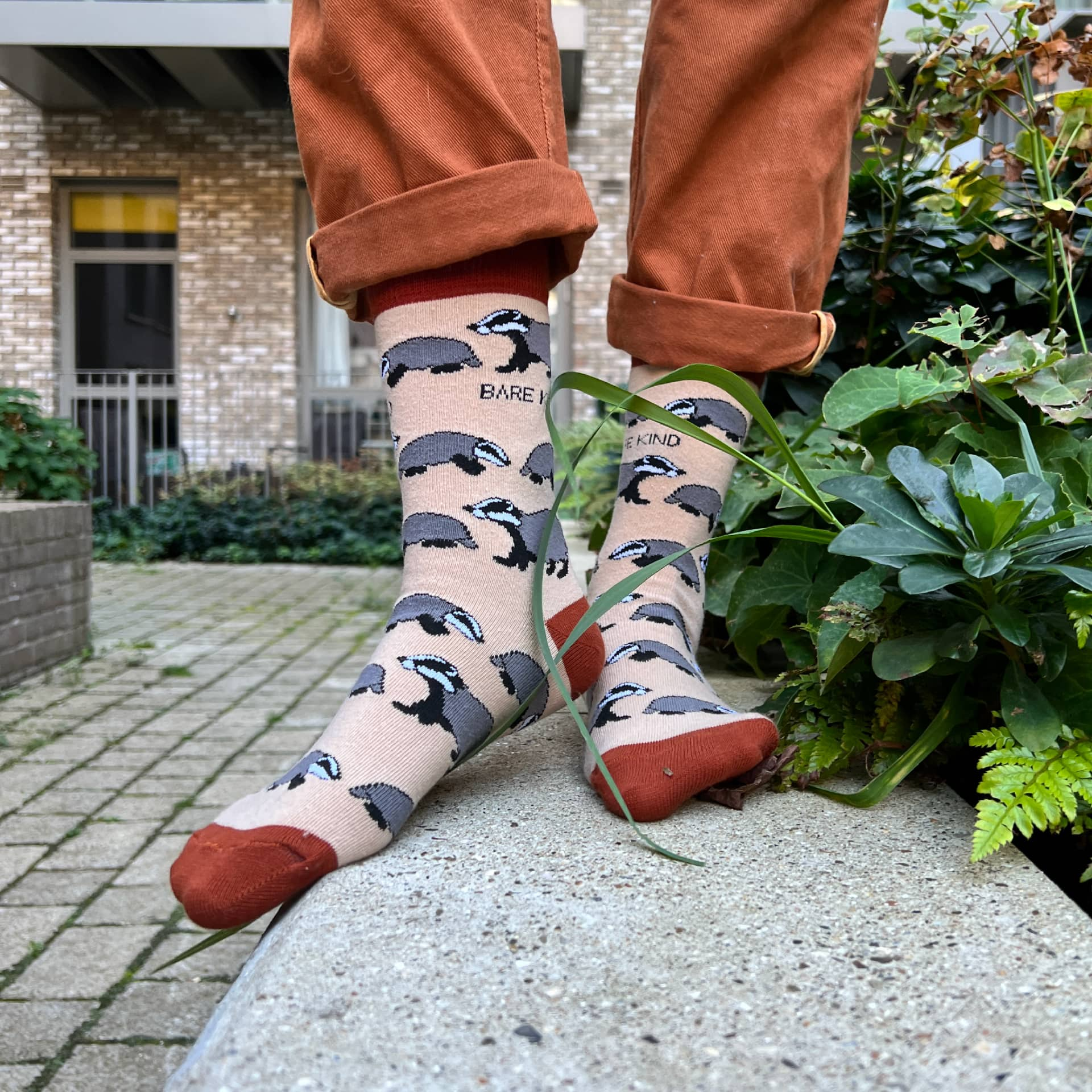 model wearing beige badger bamboo socks