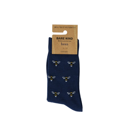 Navy blue socks with bee patterns on a white background, featuring Bare Kind packaging.