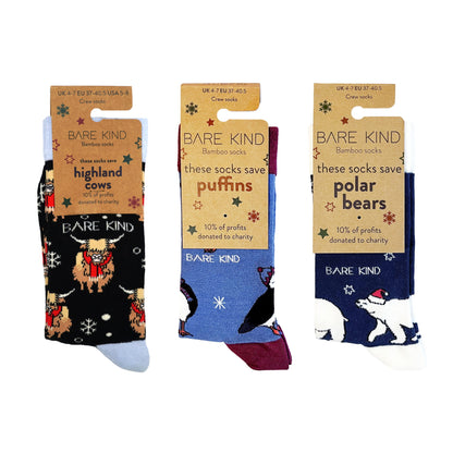 packaging flat lay image of christmas highland cow, puffin and polar bear bamboo socks in blue christmas bundle