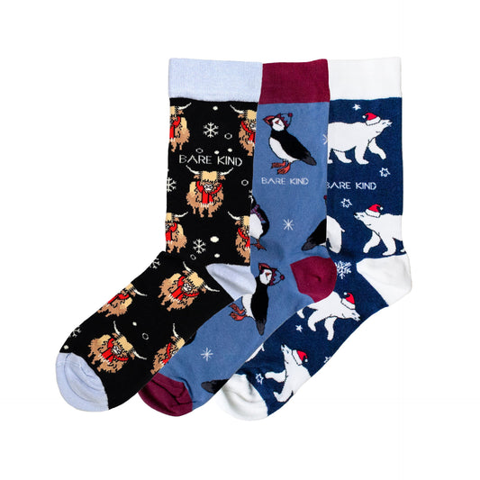 flat lay image of blue christmas bundle made up of christmas highland cow, puffin and polar bear bamboo socks