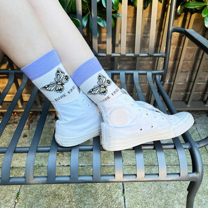 model wearing butterfly socks, side angle view