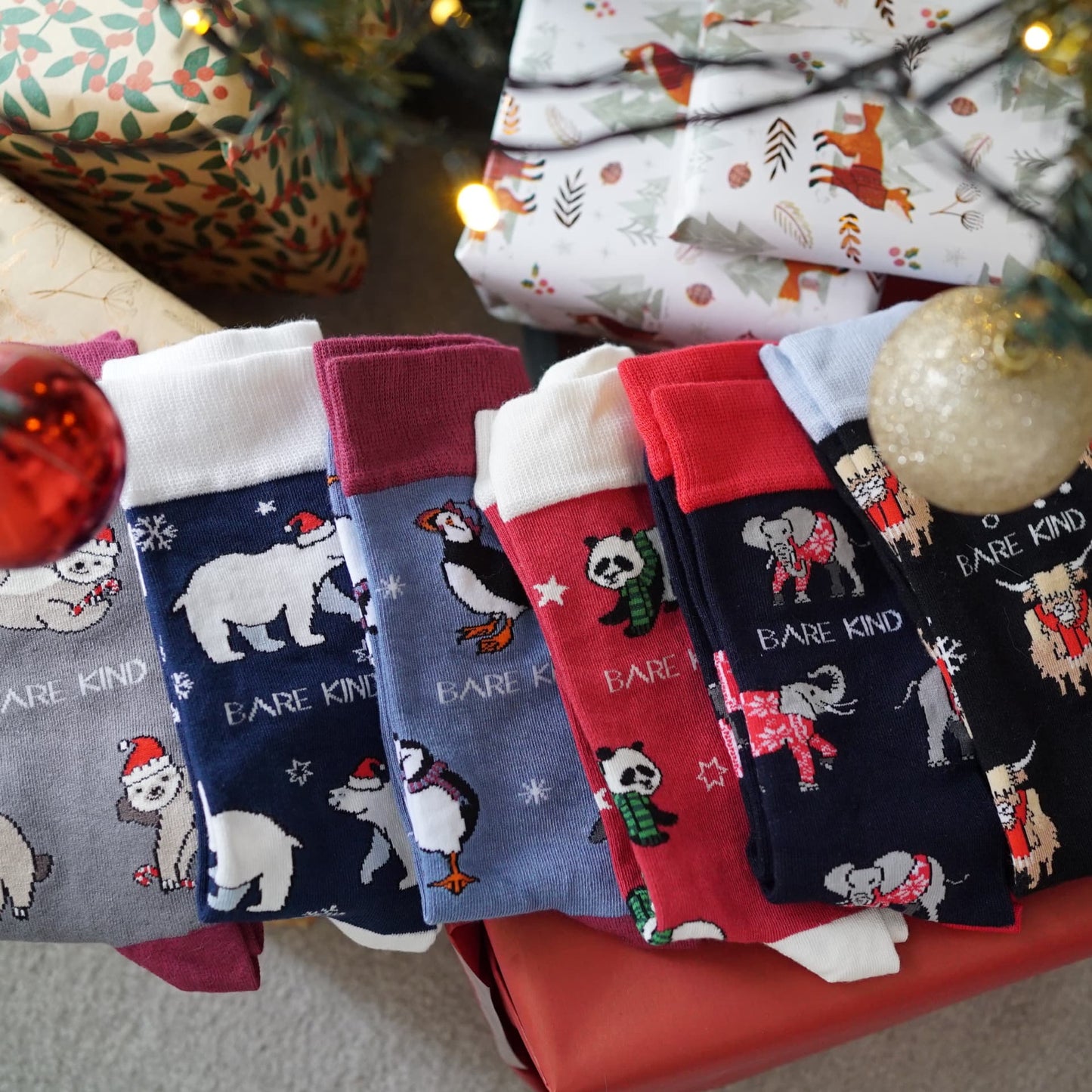 lifestyle image of 6 christmas bamboo socks under a christmas tree