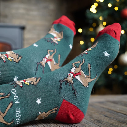 lifestyle image of model wearing green christmas reindeer bamboo socks