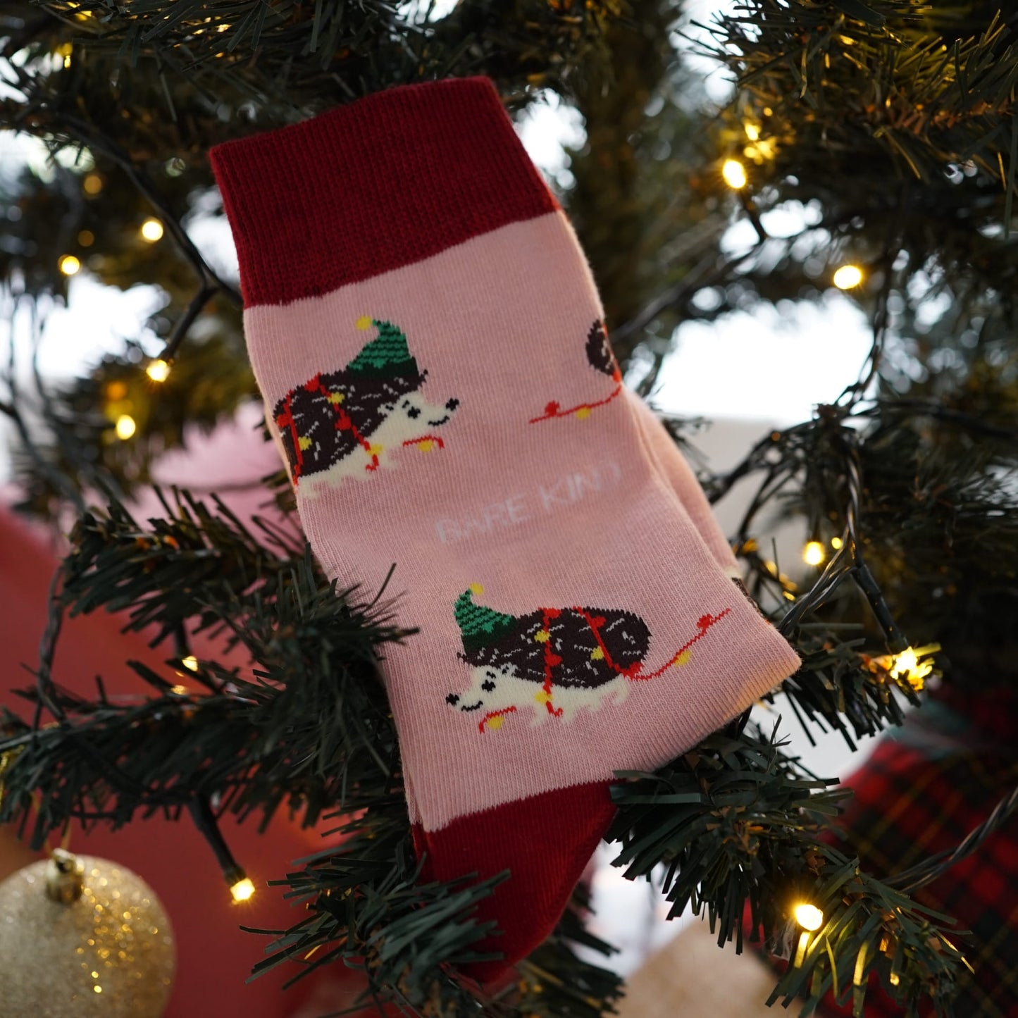 pink christmas hedgehog bamboo socks are on christmas tree