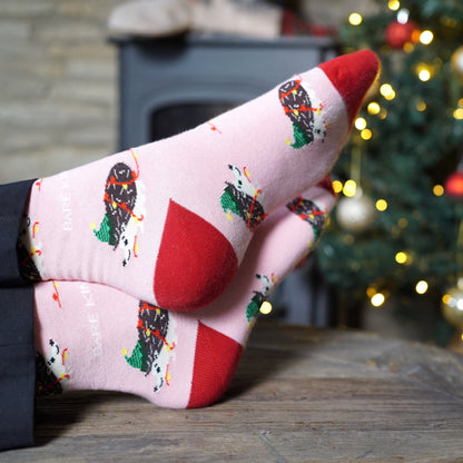 image of model wearing pink christmas hedgehog bamboo socks