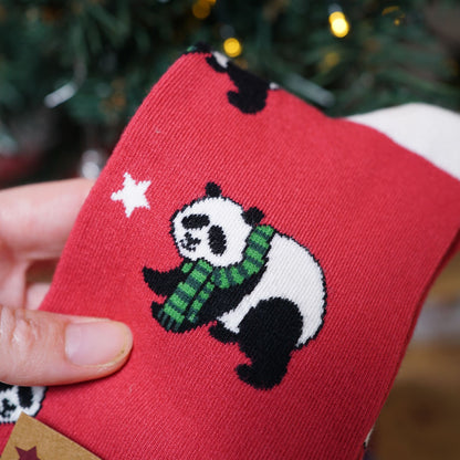 model holding the packaging of red christmas panda bamboo socks in her hand