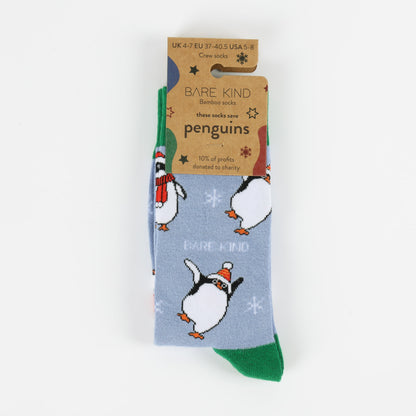 packaging flat lay of blue and green christmas penguin bamboo socks