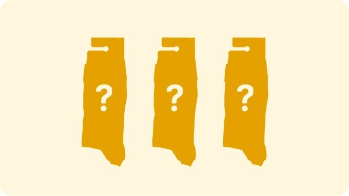Three mustard yellow packages with question marks on a beige background