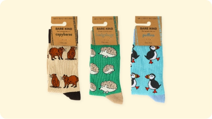 Three pairs of socks with animal patterns on packaging labeled 'Rare Kind'.