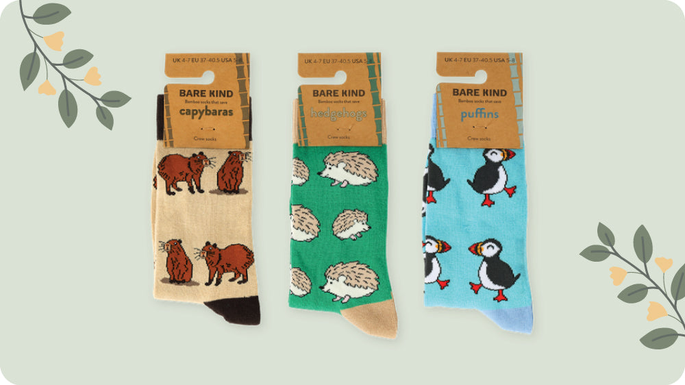 Three pairs of socks with animal patterns on packaging labeled 'Rare Kind'.