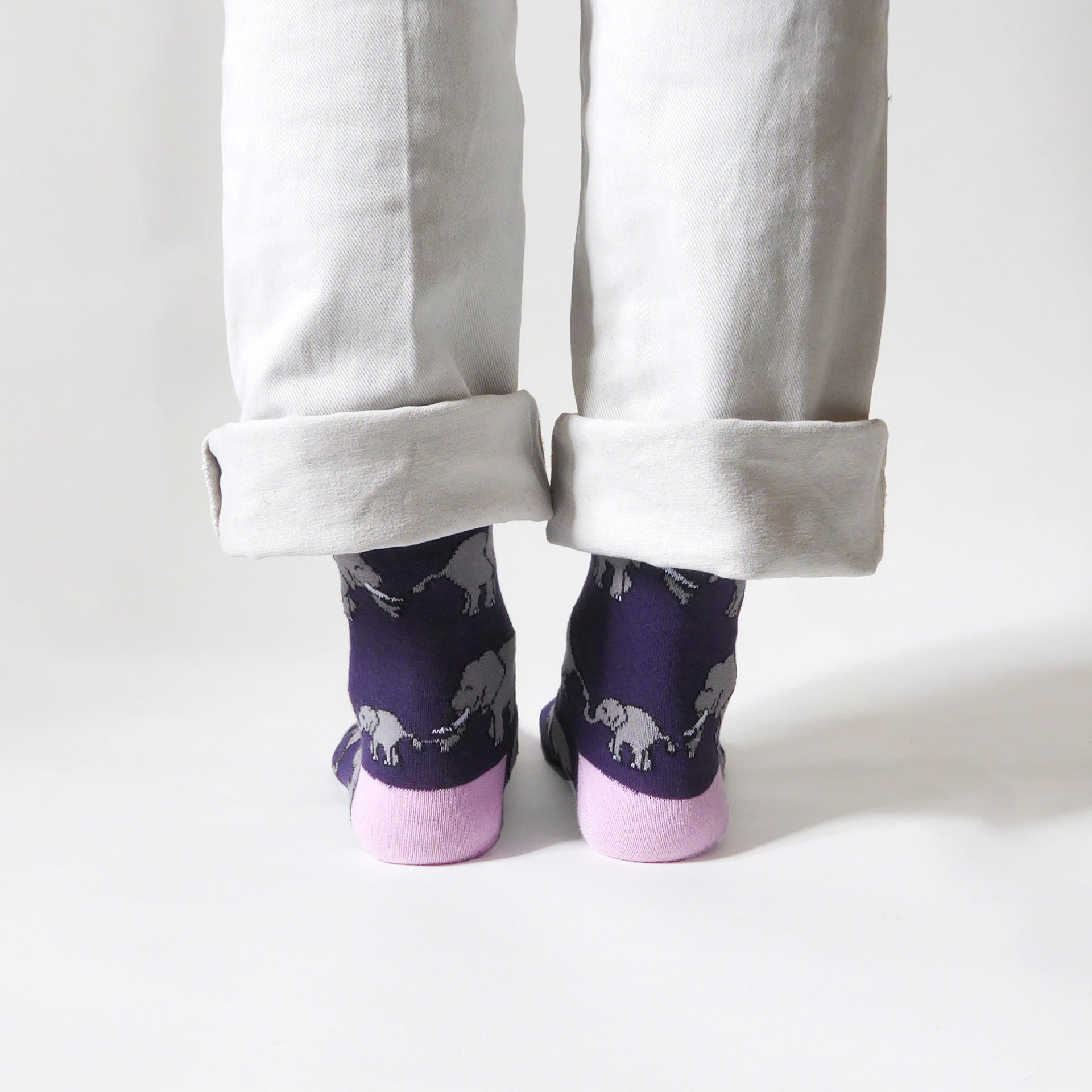 back view of standing model wearing purple and pink elephant bamboo socks