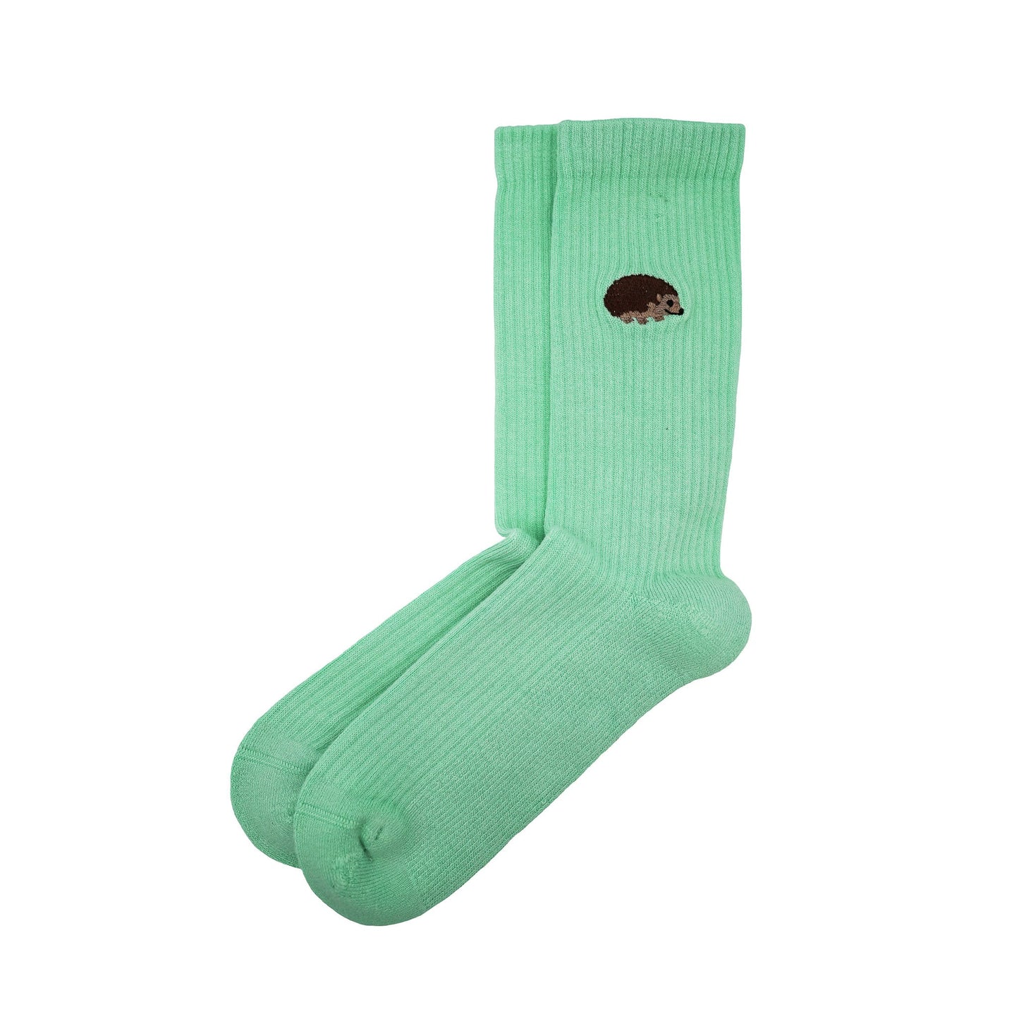 Minimalist flat lay picture of pastel green ribbed socks with hedgehog motif design