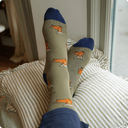 model wearing green highland cow bamboo socks