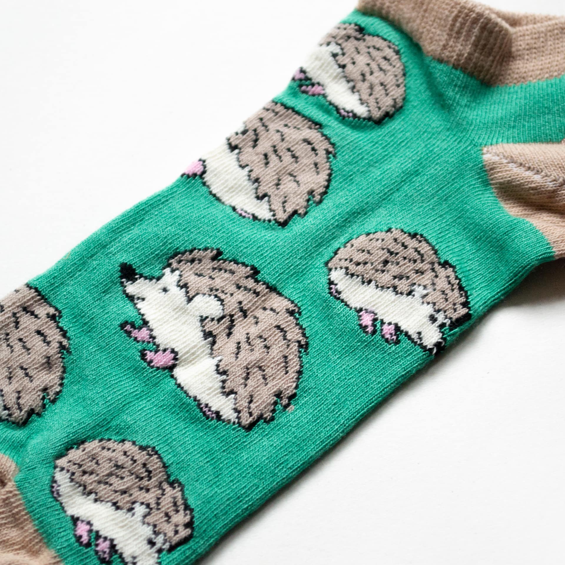 close up to green hedgehog trainer socks