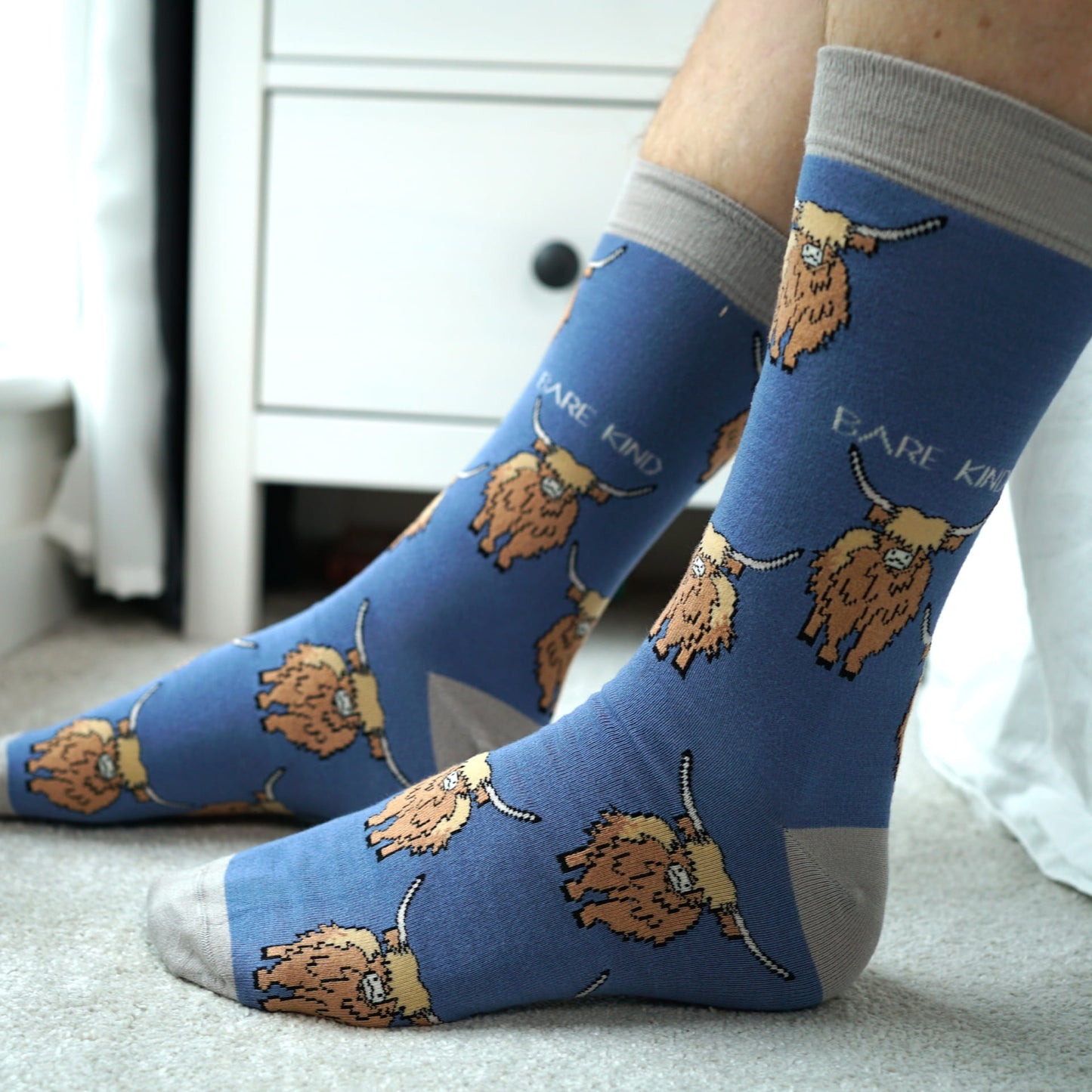 model wearing blue highland cow bamboo socks