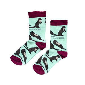 flat lay of pastel green otter socks for kids