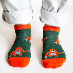 standing model wearing dark green orangutan trainer socks