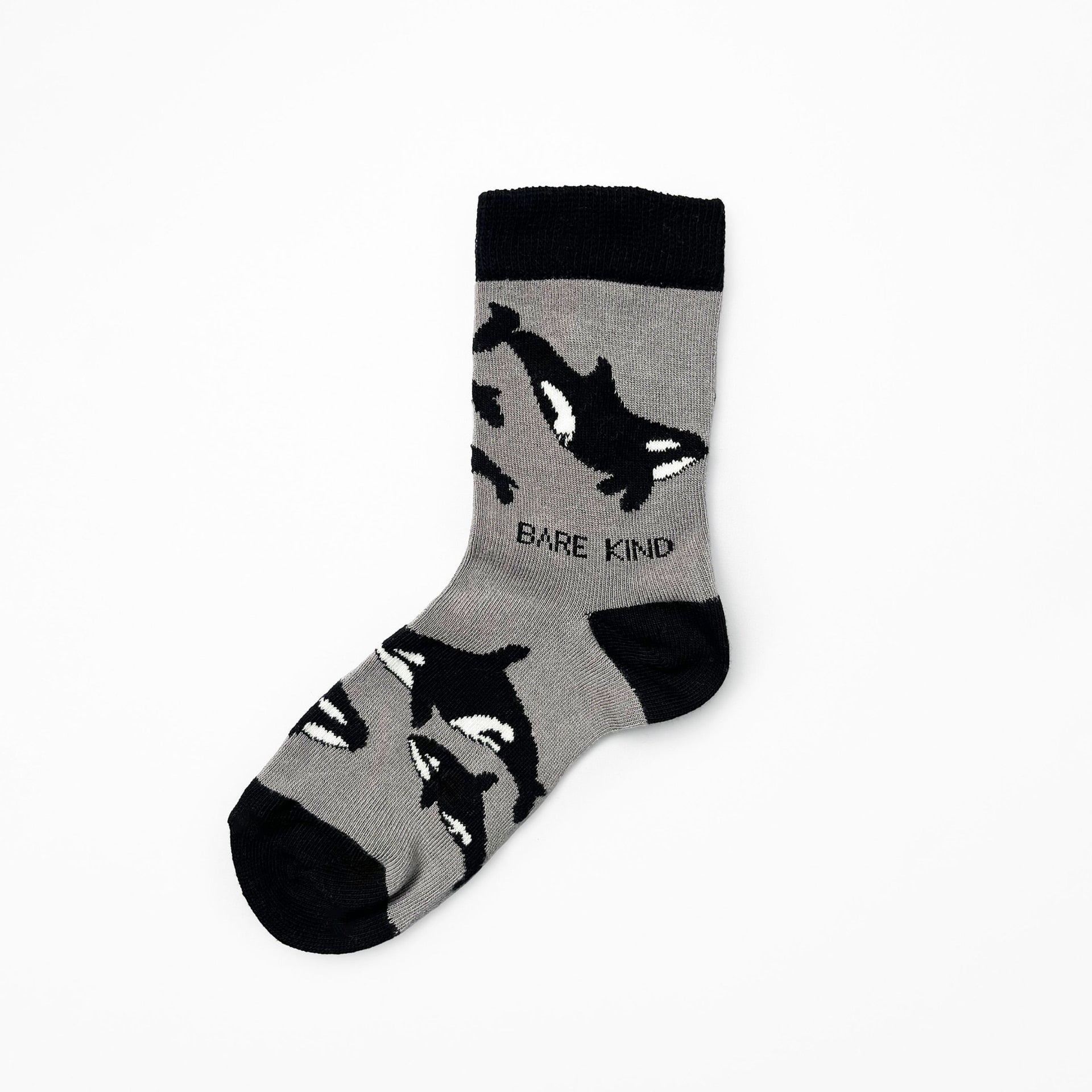 flat lay of single black kids socks in orca design