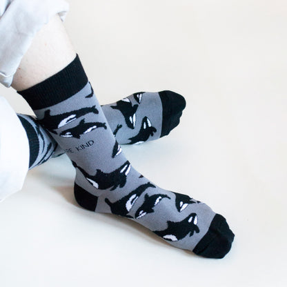 model wearing black and grey orca bamboo socks