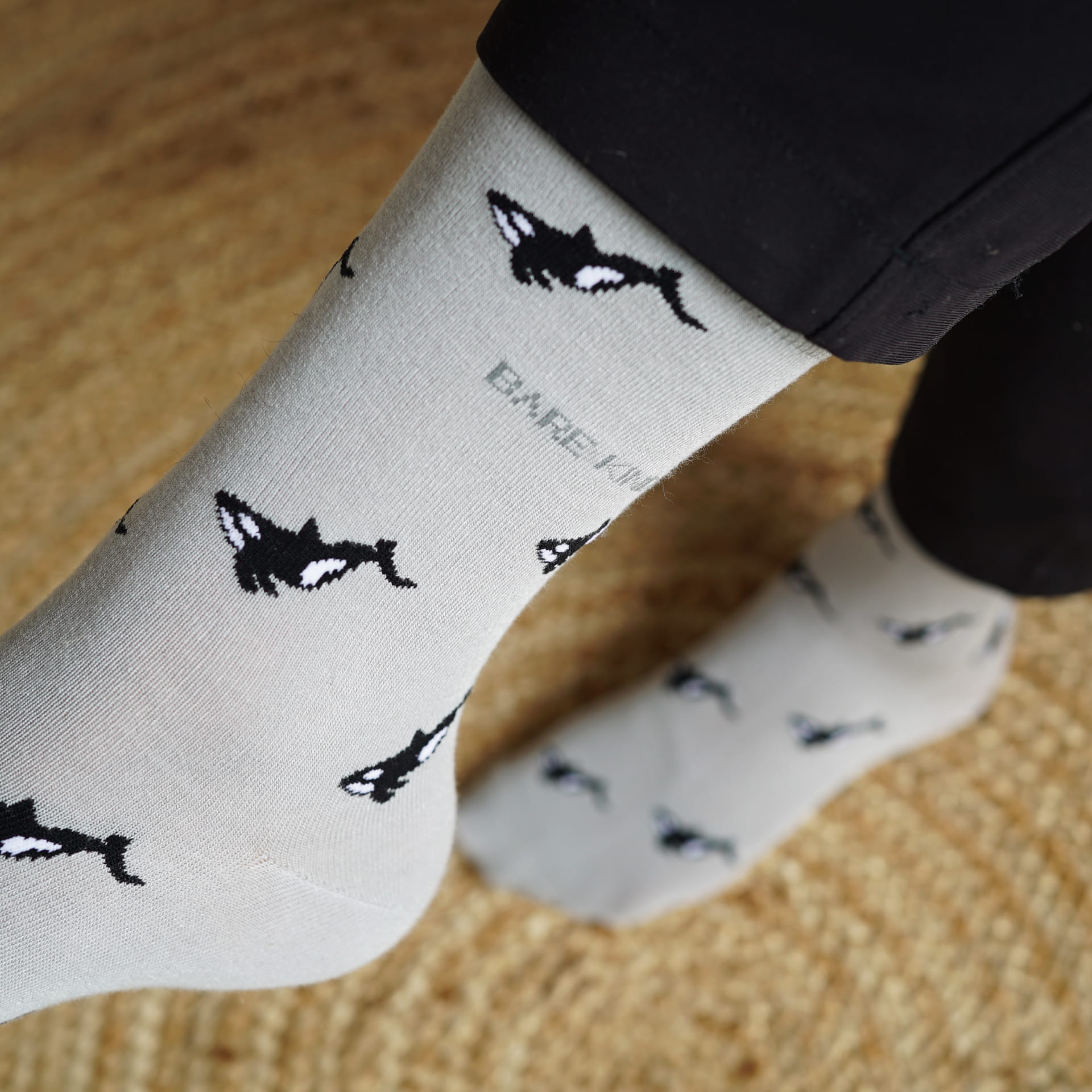 model wearing grey orca motif bamboo socks