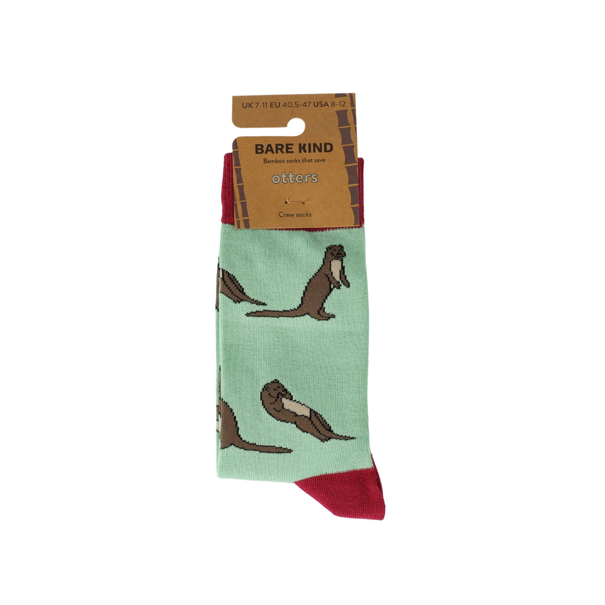 A pair of Bare Kind brand crew socks featuring a pattern of brown otters on a mint green background with dark red heels and toes, shown on a white background with its cardboard packaging.