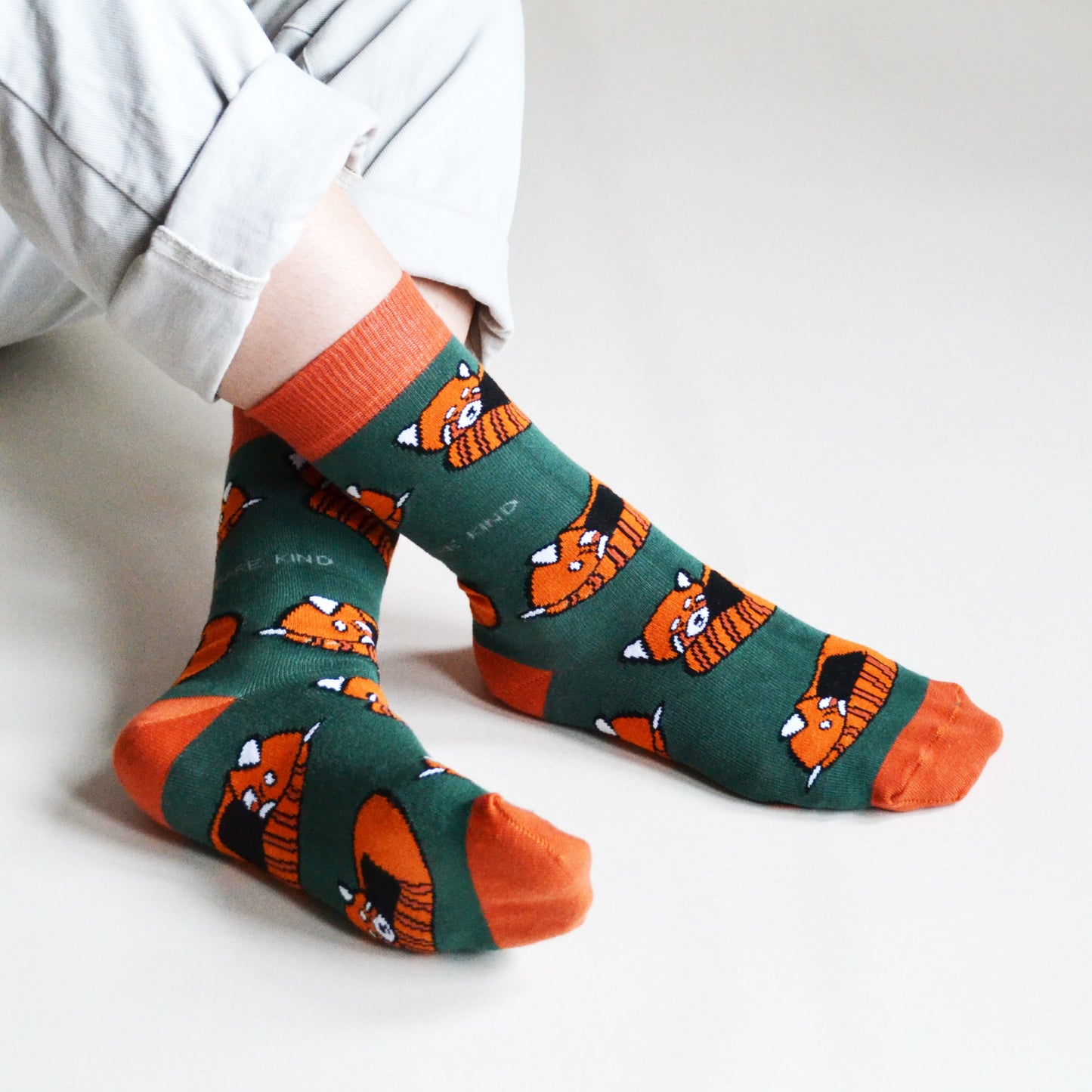 model wearing green orange red panda bamboo socks