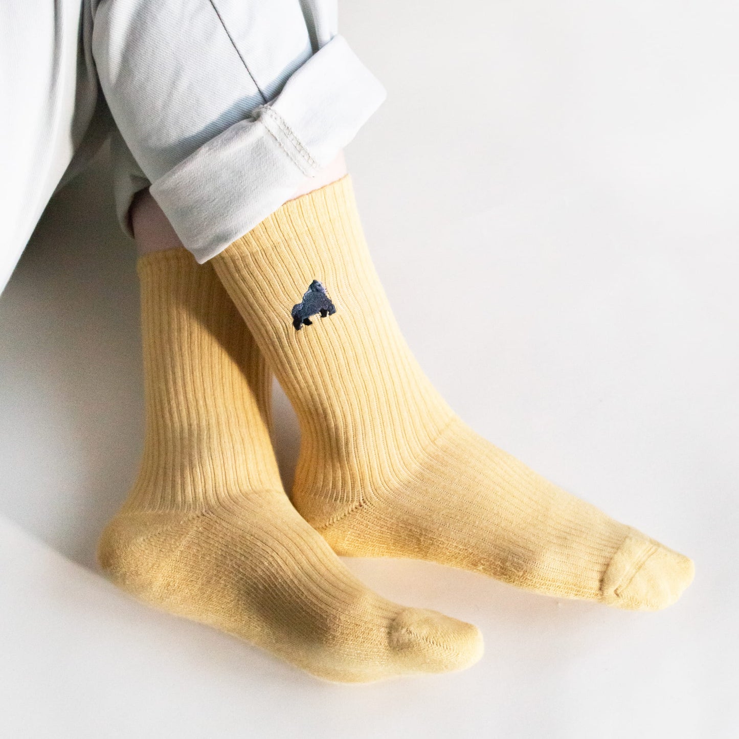 model wearing yellow ribbed gorilla bamboo socks