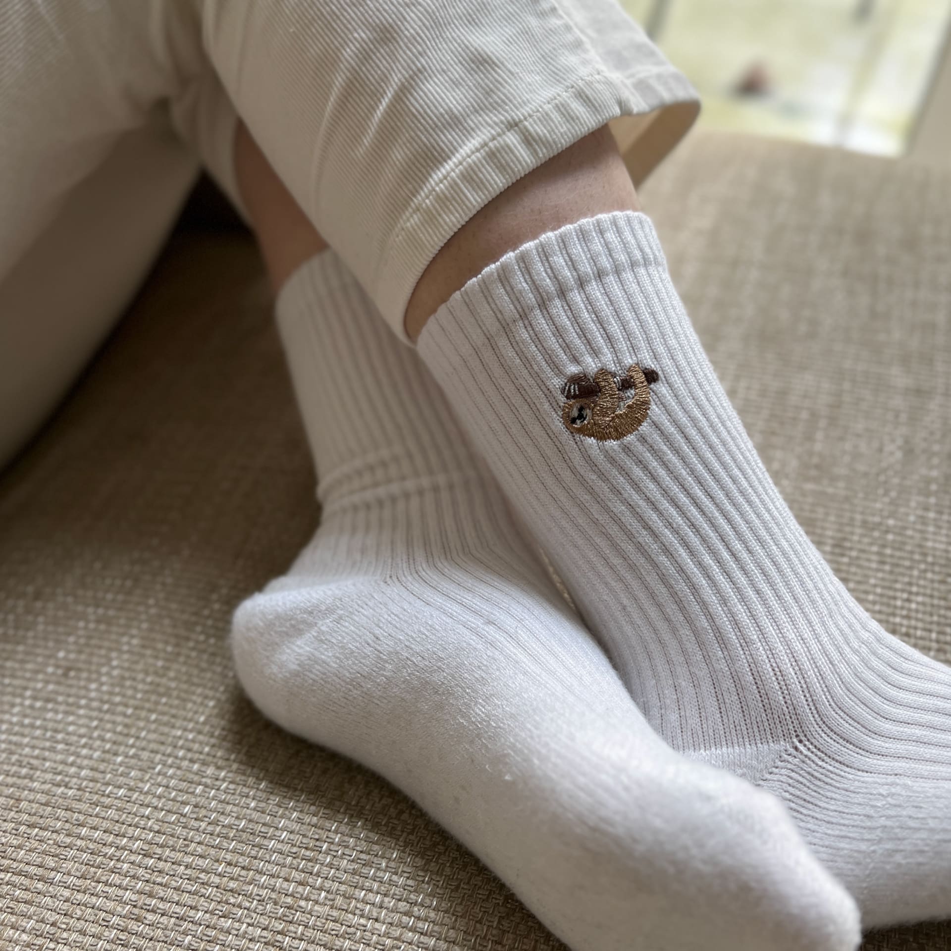 model wearing white ribbed sloth bamboo socks