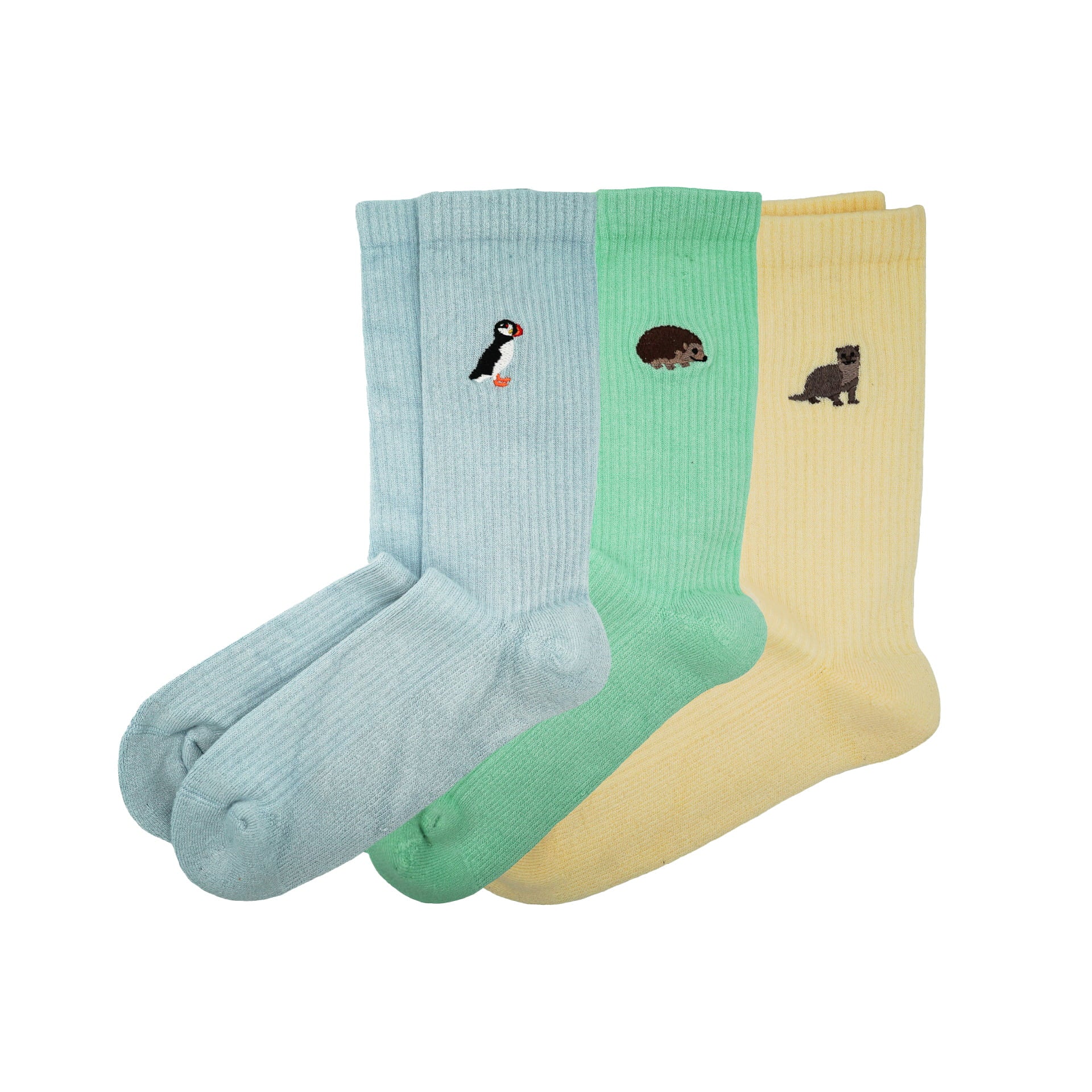 flat lays of ribbed yellow otter, blue puffin, and green hedgehog bamboo socks