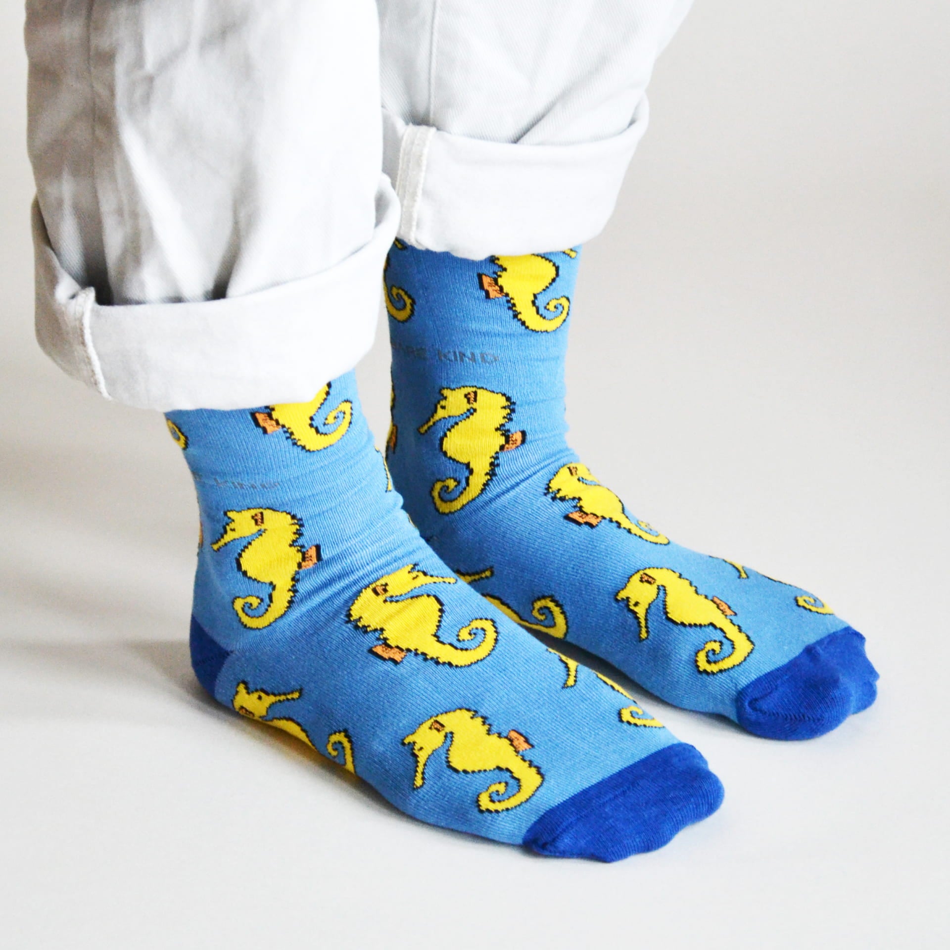 model wearing blue seahorse bamboo socks