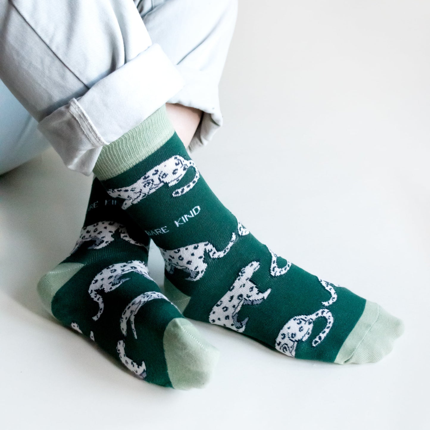 model wearing green snow leopard bamboo socks