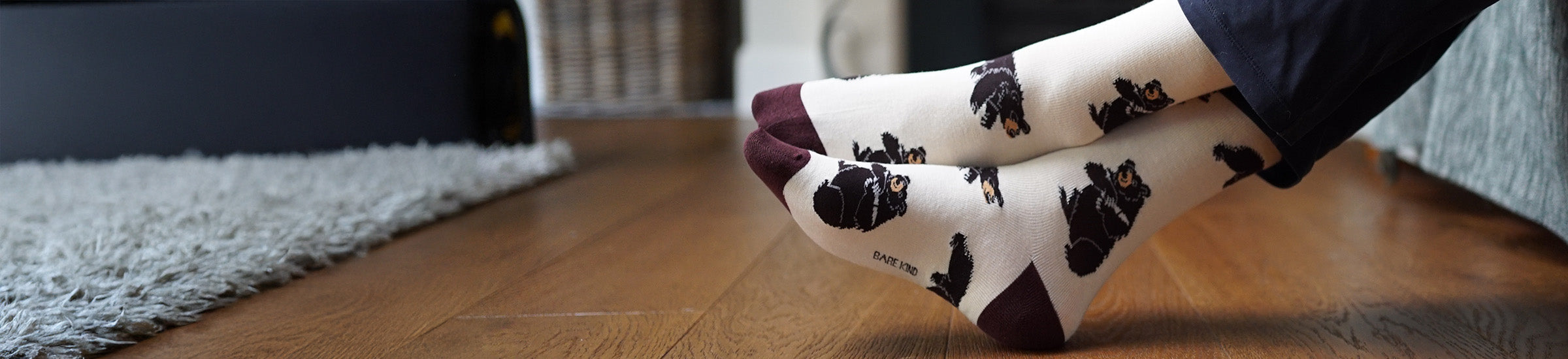 White socks with black bears on a wooden floor