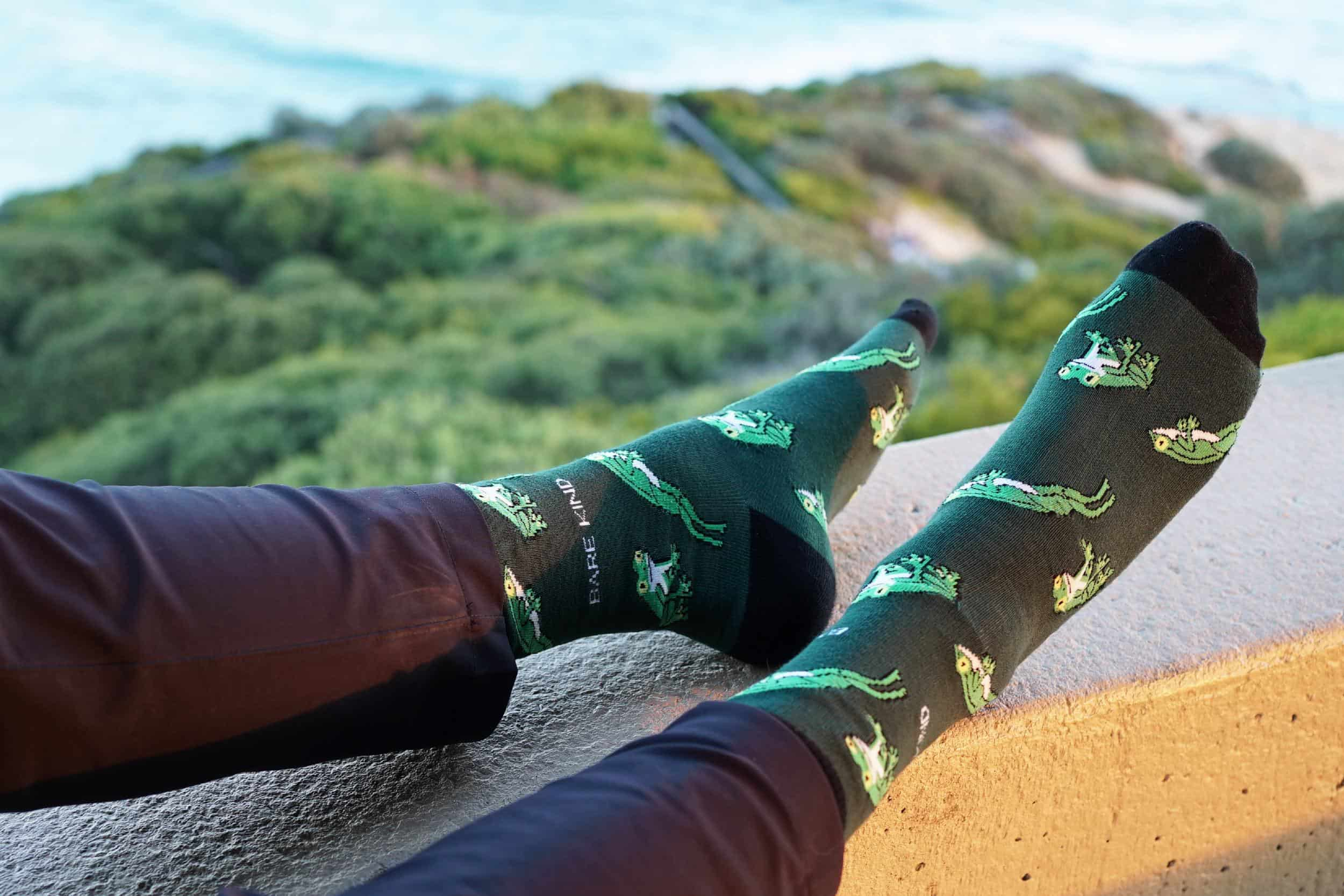 model wearing green tree frog bamboo socks