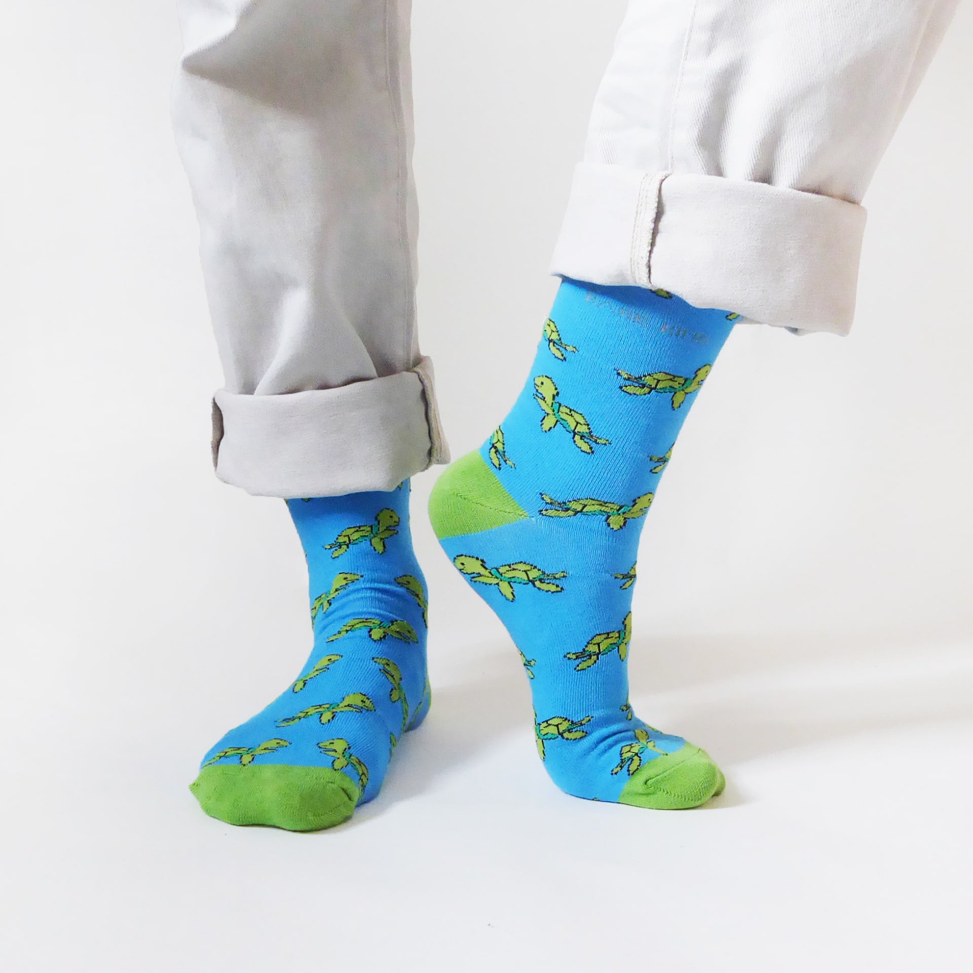 Model wearing blue green turtle bamboo socks