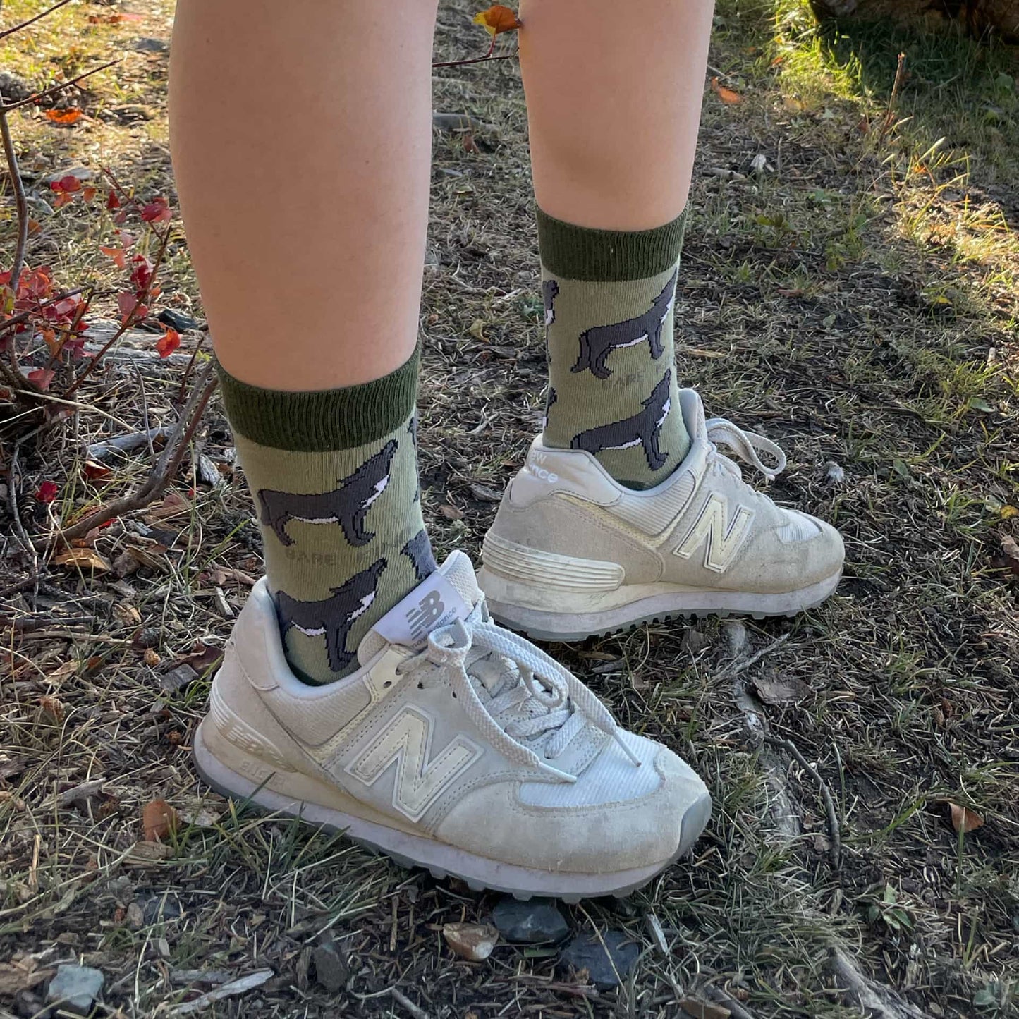 model wearing green wolf bamboo socks