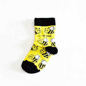 flat lay of yellow and black bamboo bee socks for kids