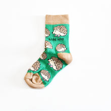 single flat lay of green hedgehog socks for kids