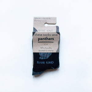 folded flat lay of black panther bamboo socks for kids in 100% recyclable packaging