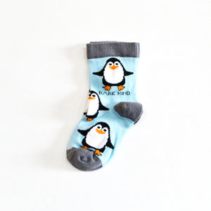 single flat lay of sky blue bamboo kids socks in penguin design