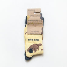 folded flat lay of pastel yellow bamboo platypus socks in 100% recyclable cardboard packaging