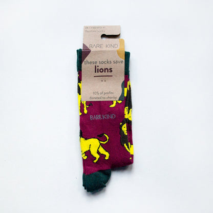 folded flat lay of burgundy red and green lion bamboo socks in 100% recyclable cardboard packaging