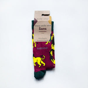 folded flat lay of burgundy red and green lion bamboo socks in 100% recyclable cardboard packaging
